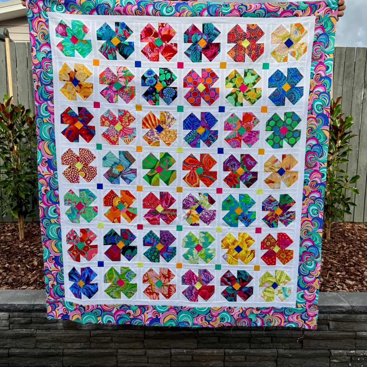 Petal Twist Quilt pattern made in Kaffe Fassett fabrics